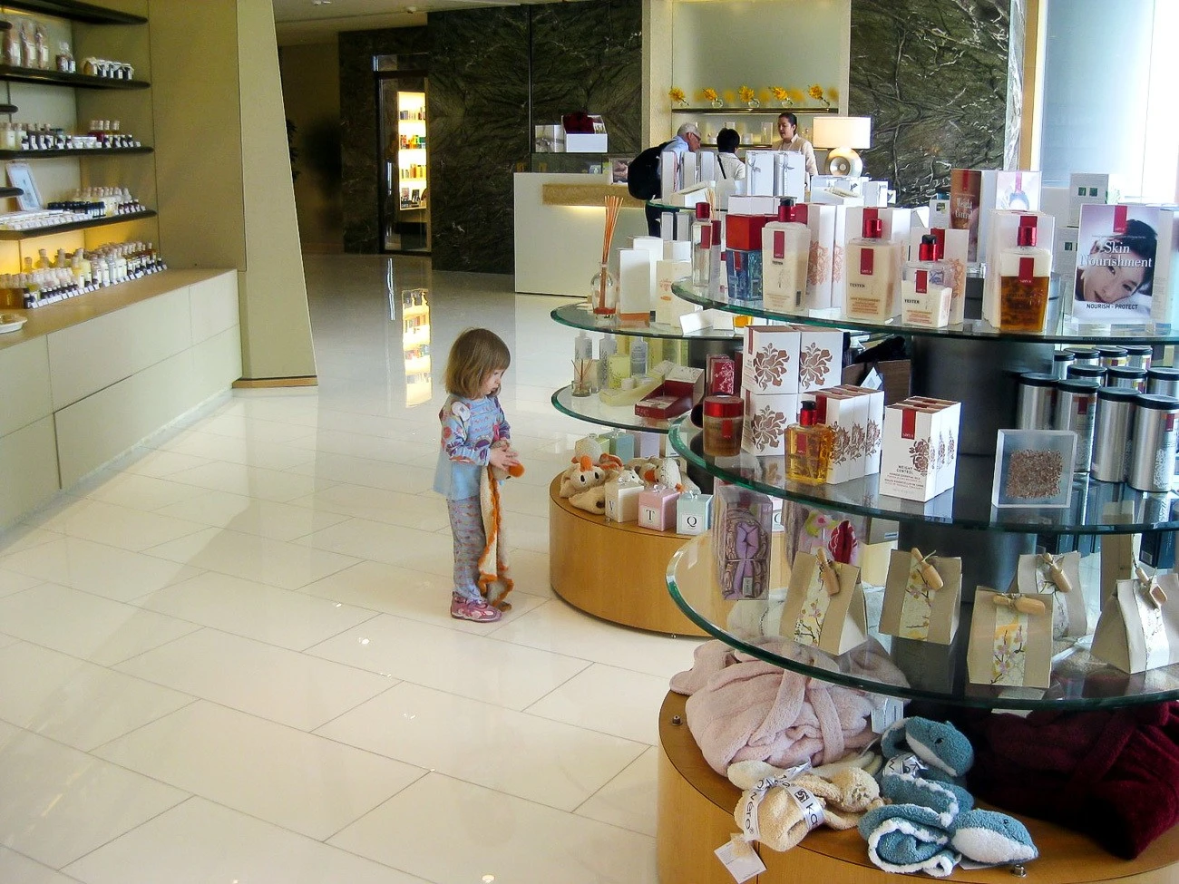 My daughter at age two looks at kids' blankets in the spa boutique.