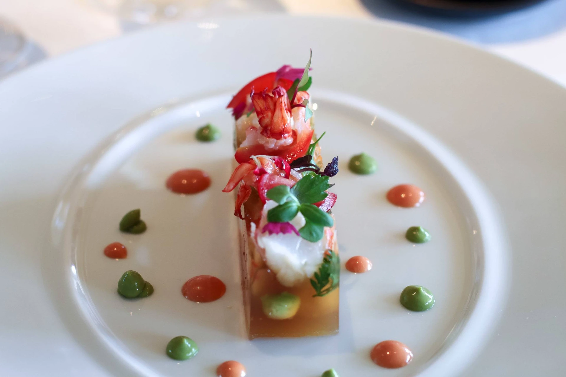 Beautifully-plated lobster terrine on a white plate at Caprice.