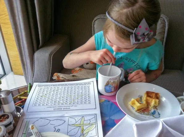 My daughter sips juice from special kids' dishes in The Lounge at Four Seasons Hong Kong.