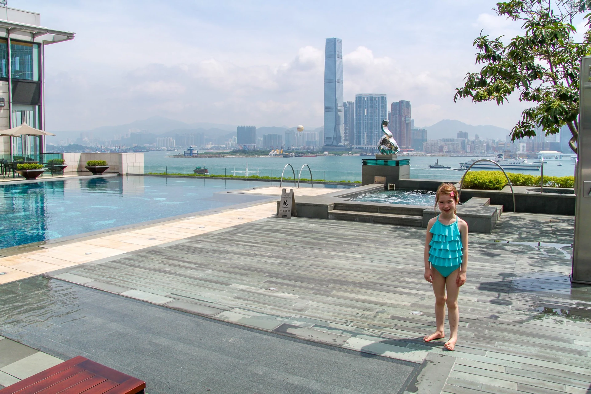 The Four Seasons Hotel Hong Kong Pool with Kowloon and the harbour in the background. 