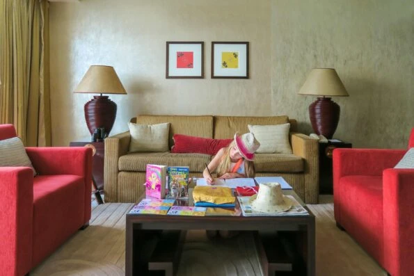 My daughter completes schoolwork on the table of a Harbour View Suite at Four Seasons Hong Kong.