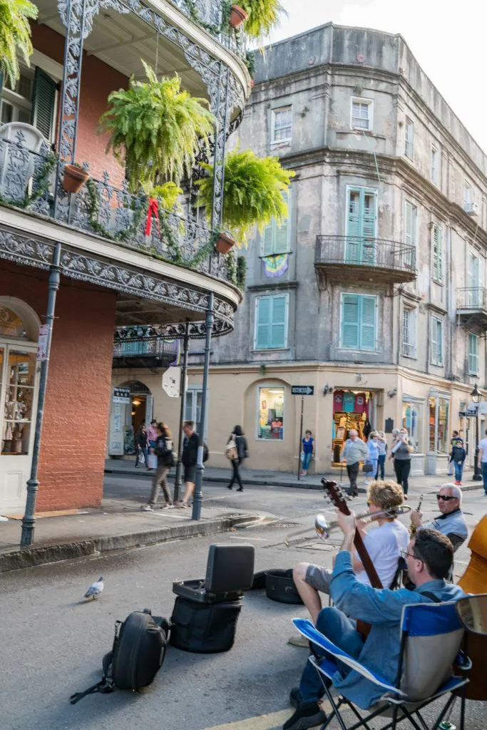 Musicians entertain while shoppers browse the French Quarter in New Orleans.