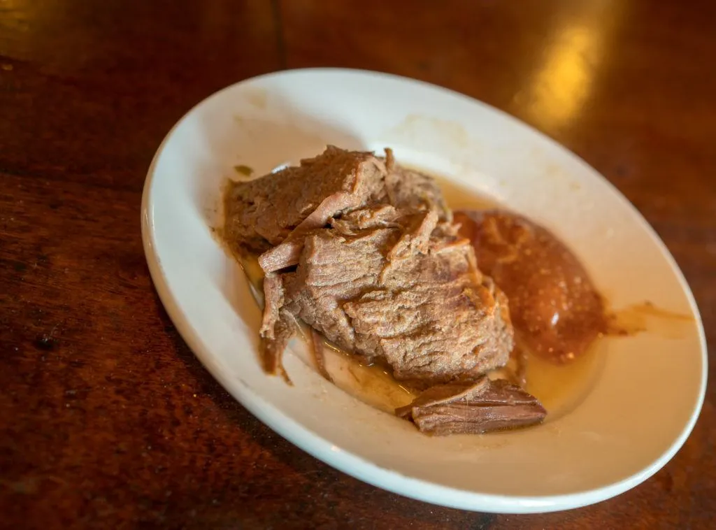 Brisket in sauce on a plate at Tujague's, New Orleans