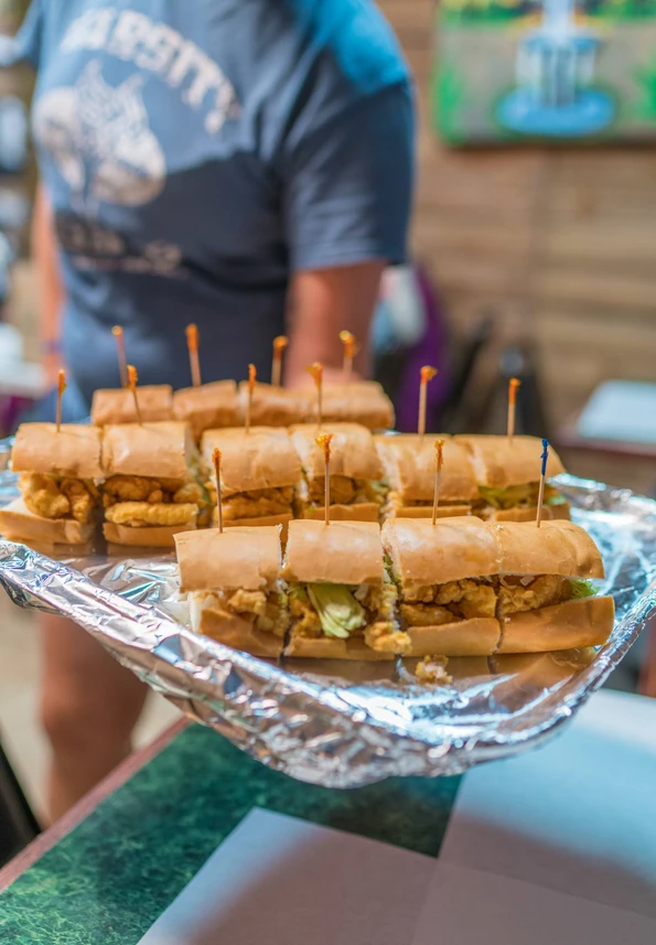 A giant po' boy sandwich cut into sections for tasting.