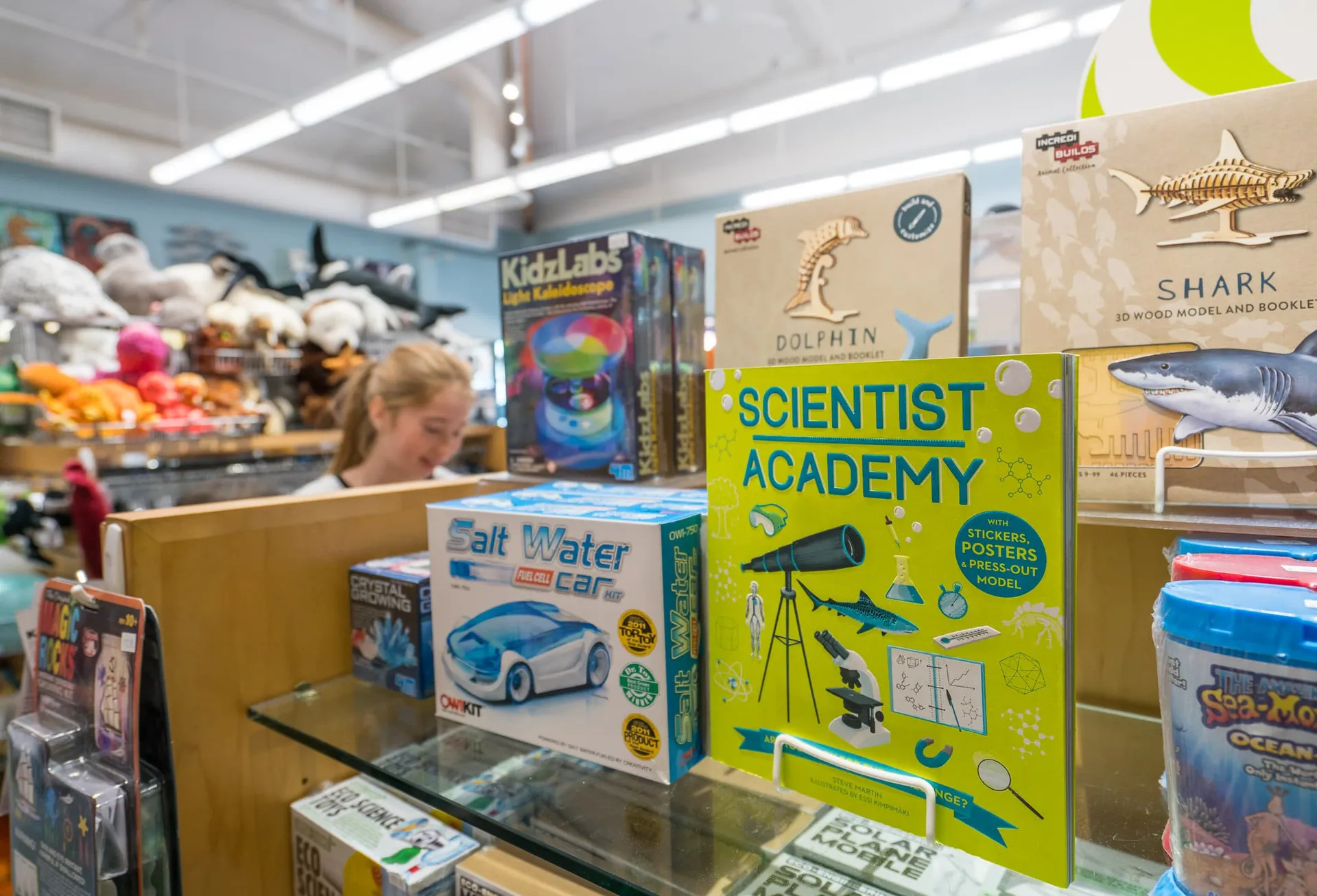 My daughter browses books and games at the Gift Shop.