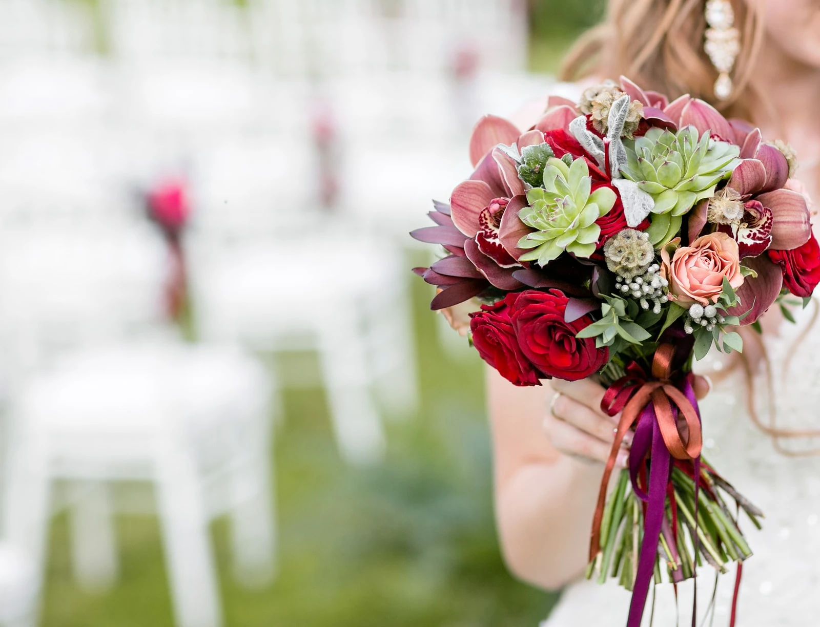 Succulent bouquet with roses and orchids.