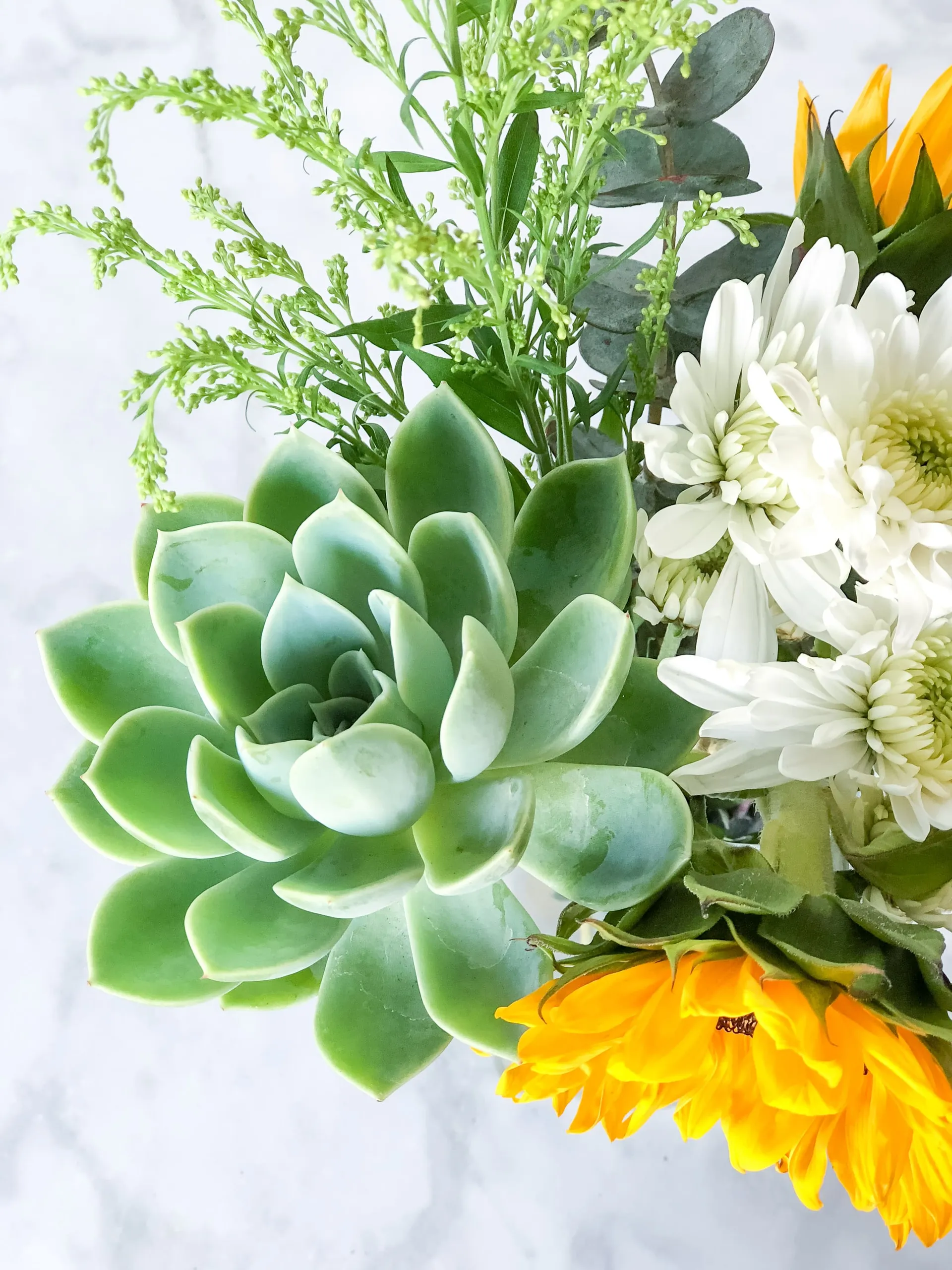 A bouquet of sunflowers and succulents