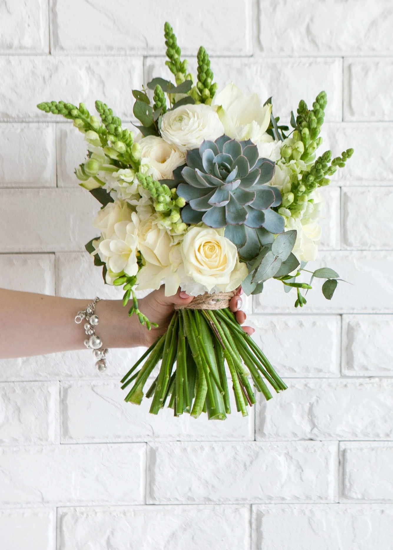 Succulent bouquet with white roses