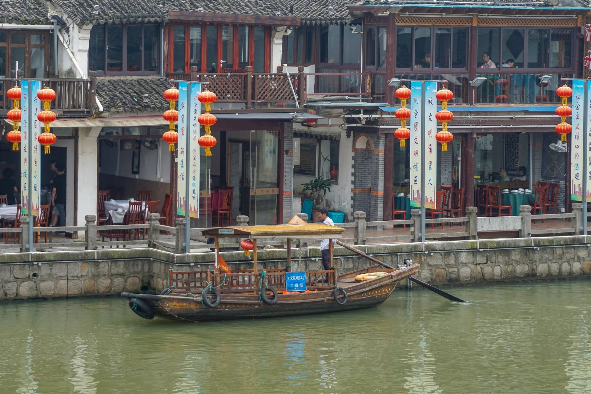 A boat docked on the canal waiting for tourists during our day trip from Shanghai to Zhujiajiao water town