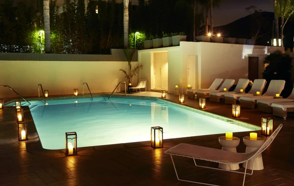 The outdoor swimming pool lit up at night.