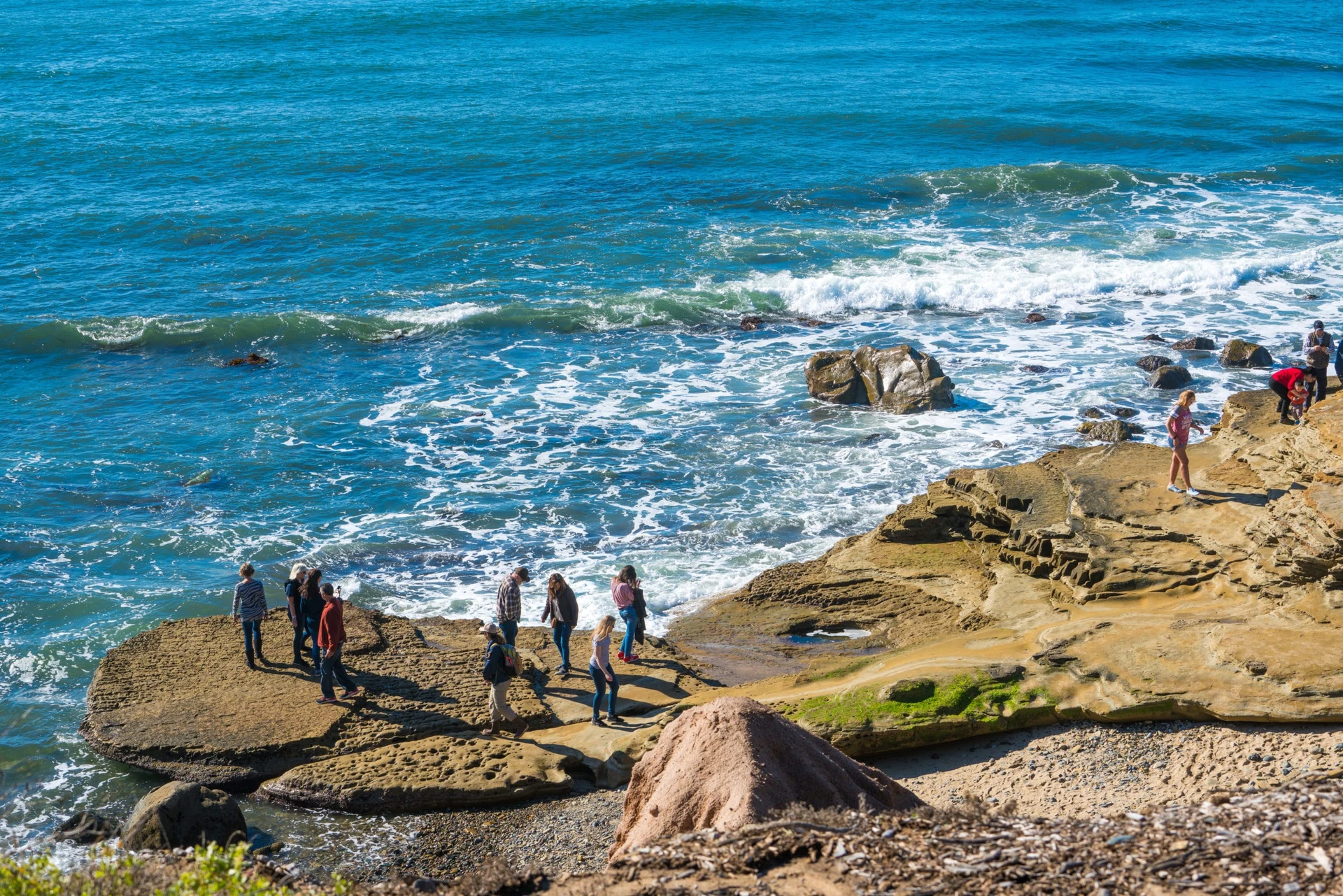 People look at tide pools at Cabrillo National Monument, one of the fun San Diego kid activities in winter. 