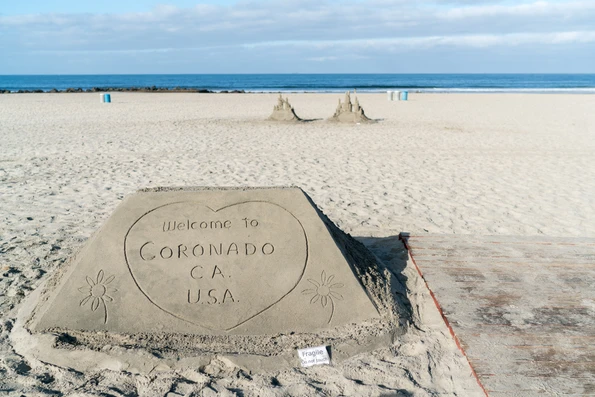 Kids love the sandcastle man in front of Hotel Del Coronado