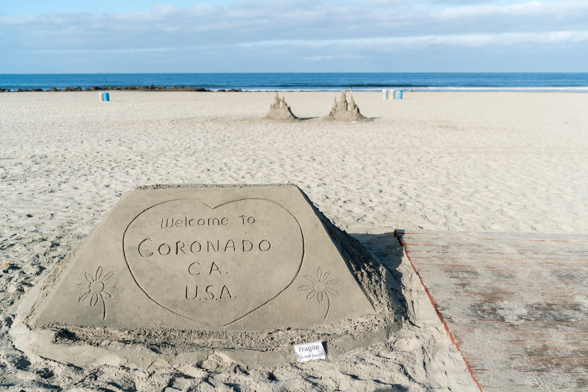 Kids love the sandcastle man in front of Hotel Del Coronado