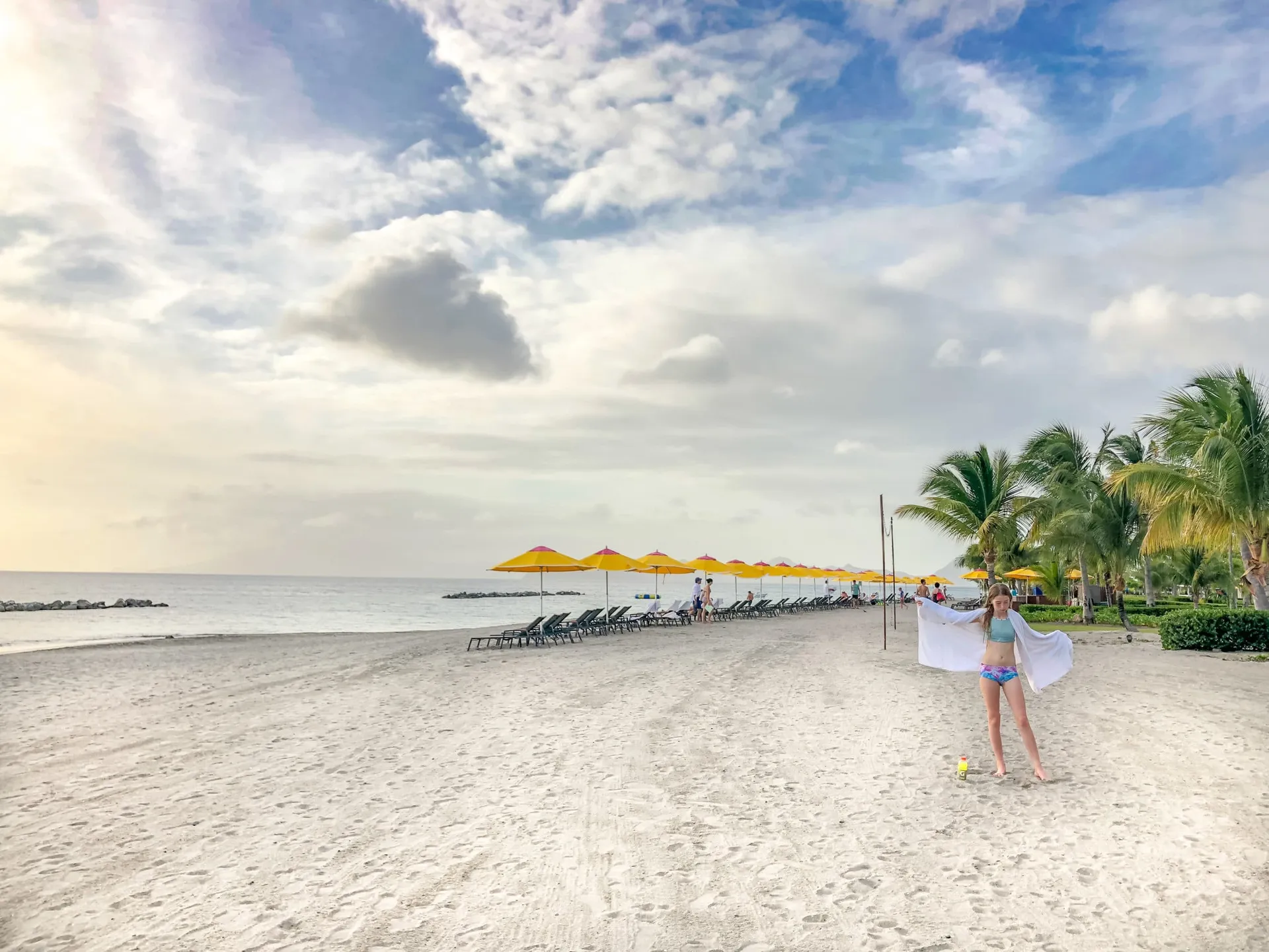 My daughter stands on the sand in front of Four Seasons Resort Nevis, West Indies.