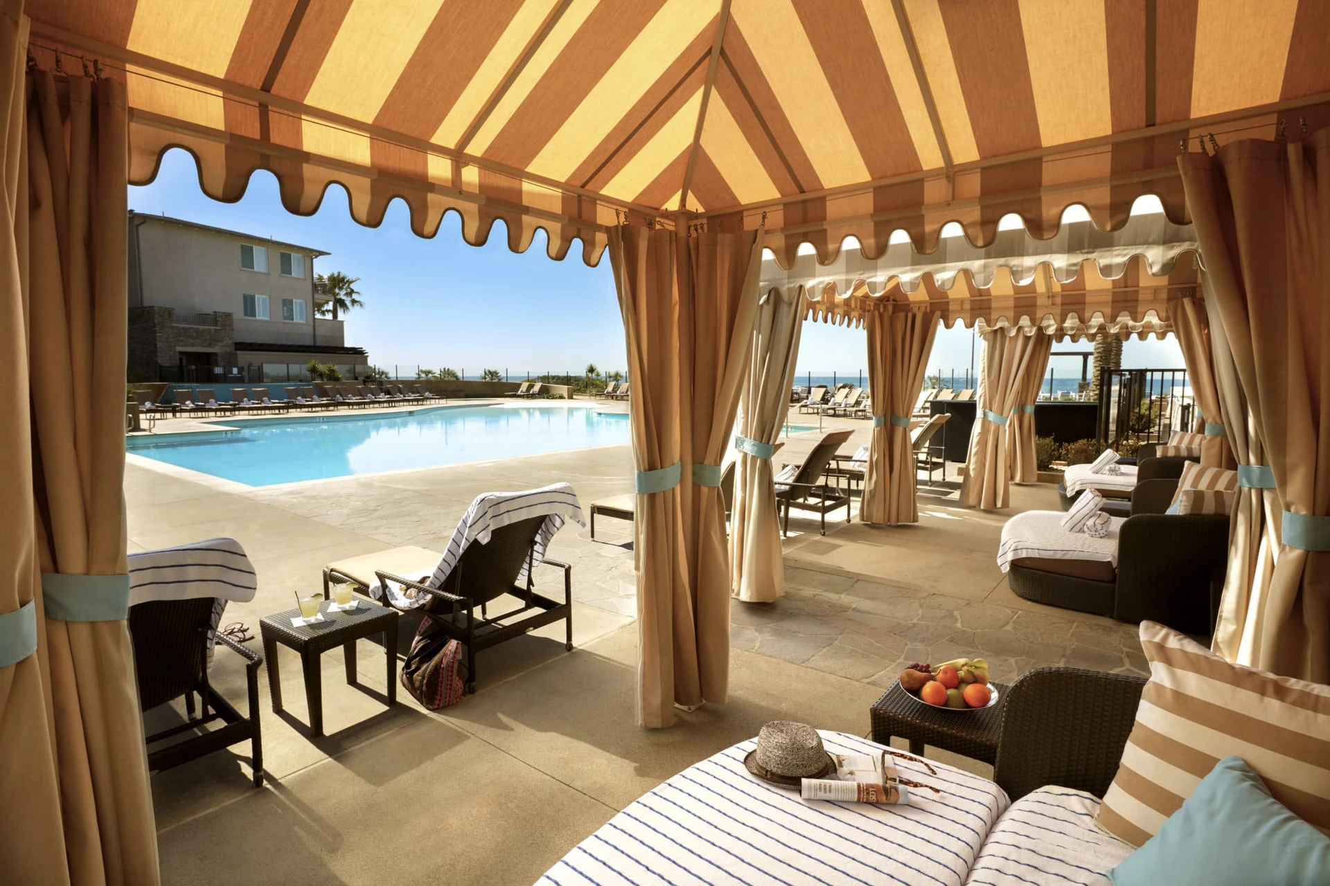 View from a shaded pool cabana looking out to the outdoor pool.