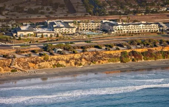 Aerial view of the ocean and entire Cape Rey Carlsbad, a Hilton Resort.
