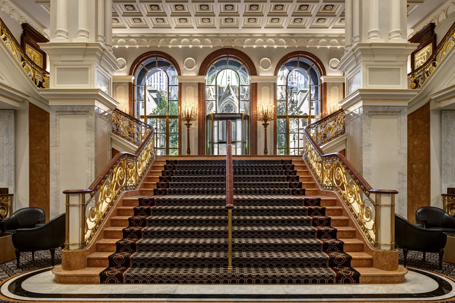 The grand interior staircase at Lotte New York Palace