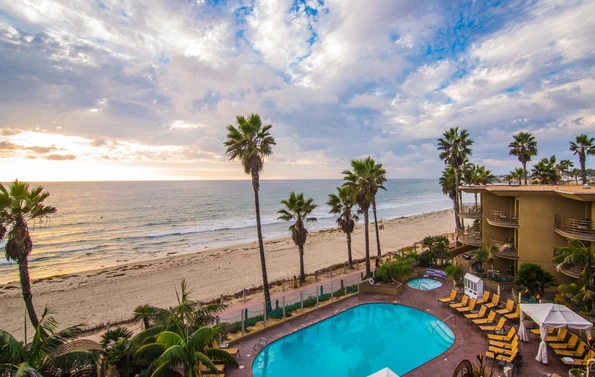 View over the Pacific Terrace Hotel swimming pool to the beach and ocean. 