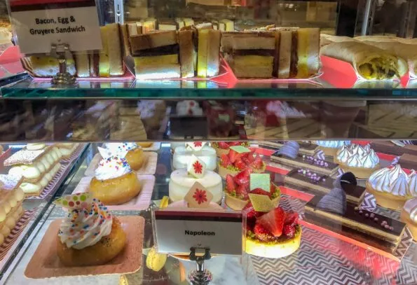 Desserts in a pastry case at Pomme Palais patisserie.