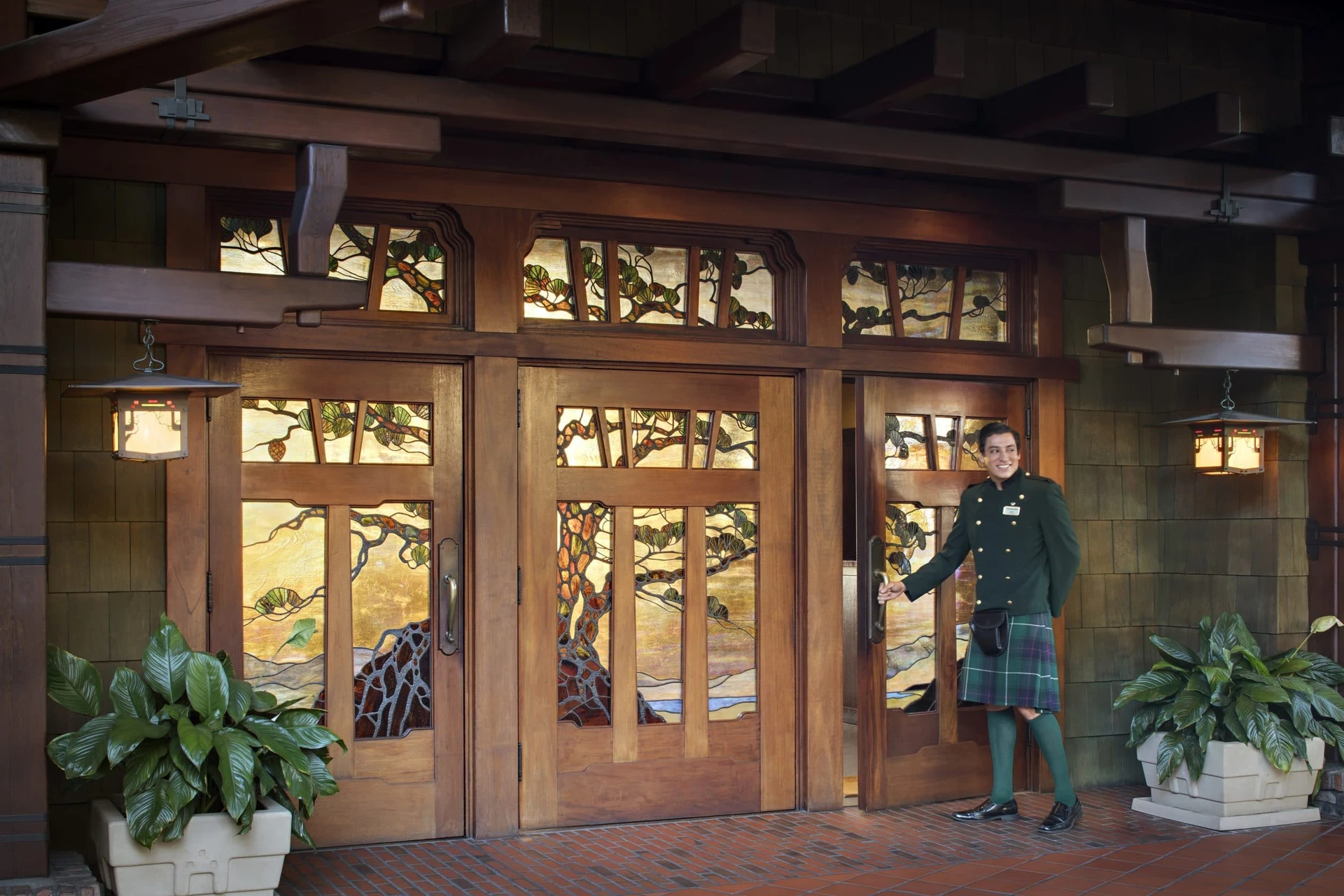 A kilted doorman opens the stained glass door to the lobby at The Lodge at Torrey Pines