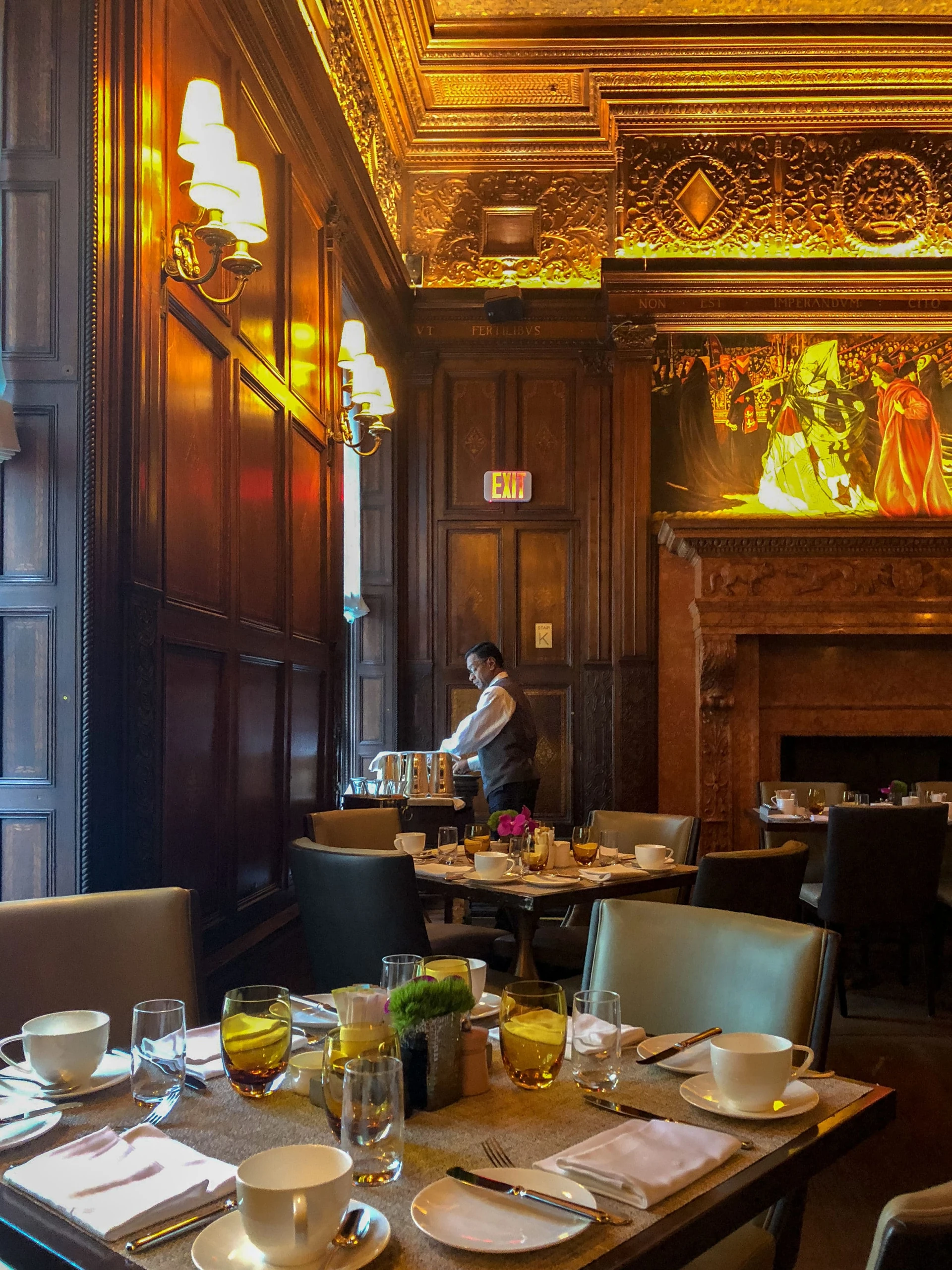 A server prepares water pitchers in the main dining room of Villard.