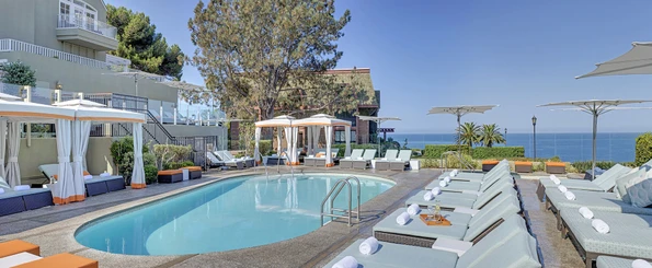 L'Auberge Del Mar hotel pool surrounded by lounge chairs