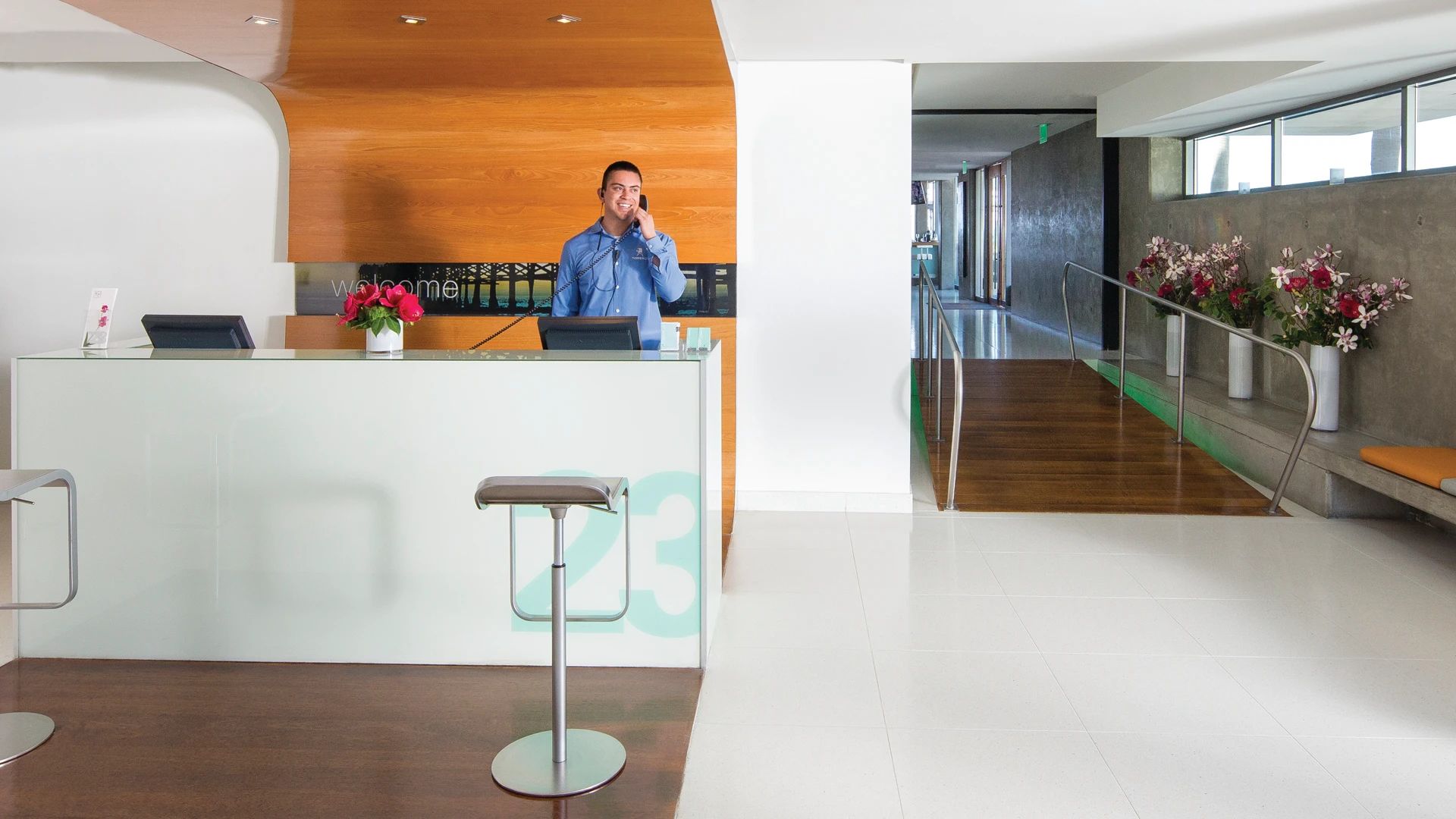 A man answers the phone at the front desk.