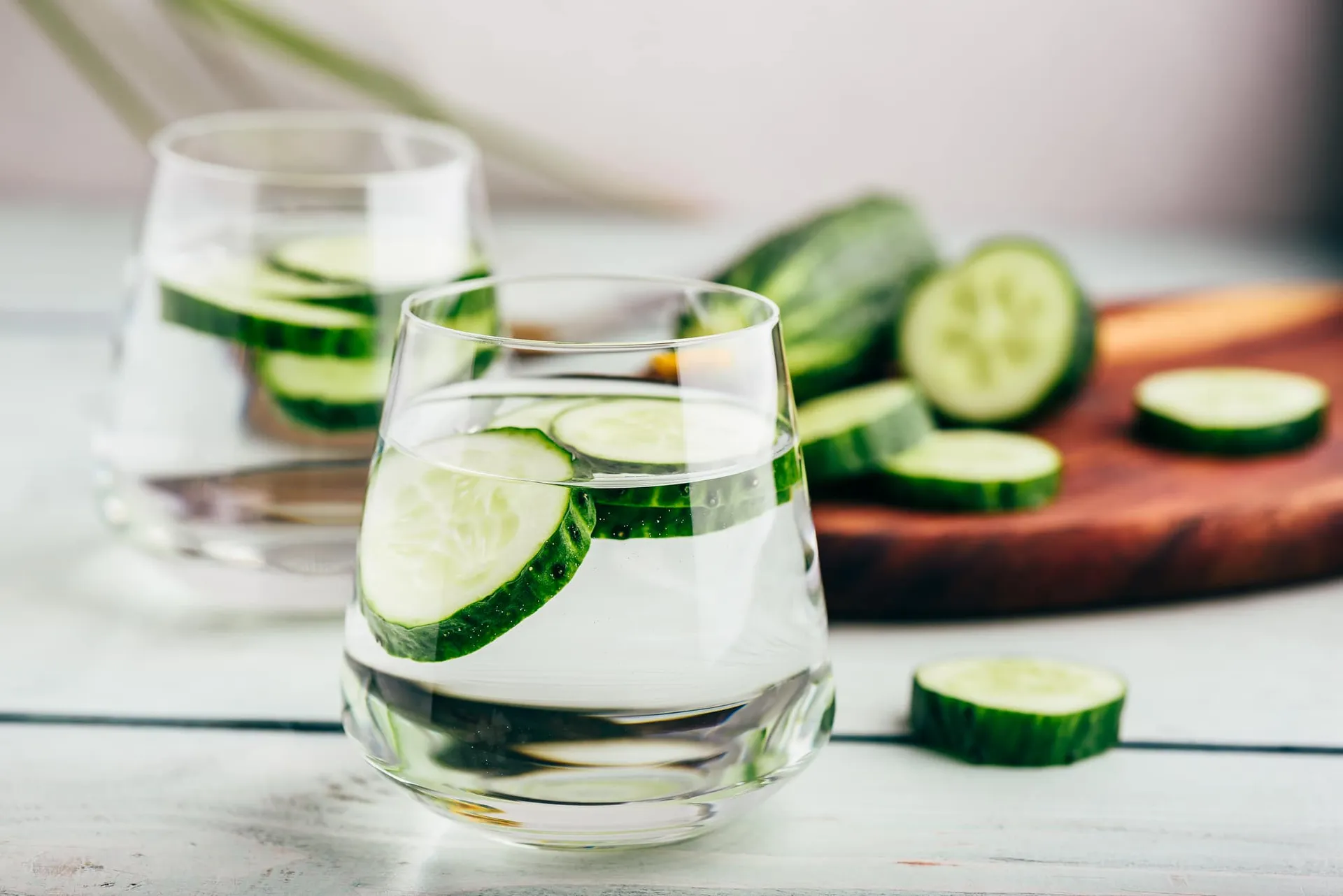 Water with cucumber in it illustrating health benefits of cucumber water.