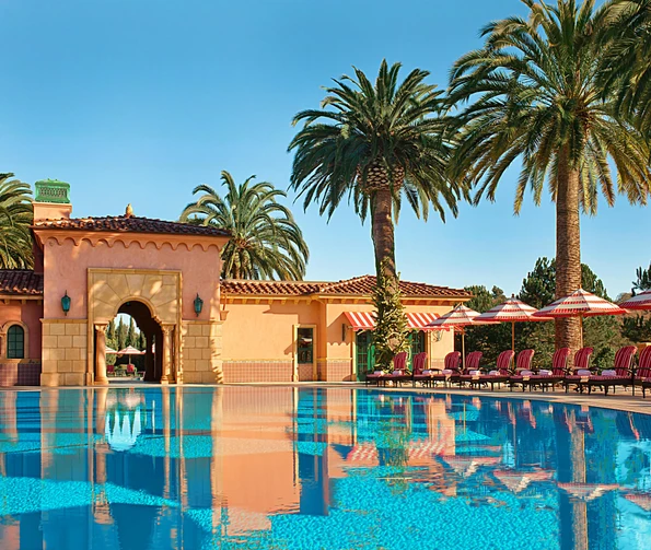 View of the main pool area with palm trees at Fairmont Grand Del Mar, one of the best resorts in San Diego.