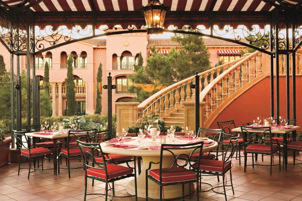 Tables and chairs set for guests on the outdoor terrace at Amaya restaurant.