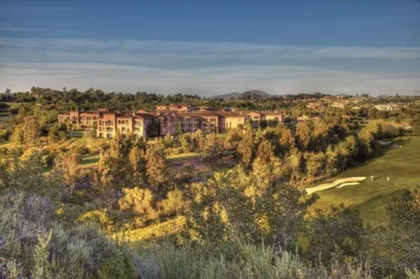 Aerial view of the resort and golf course at golden hour.