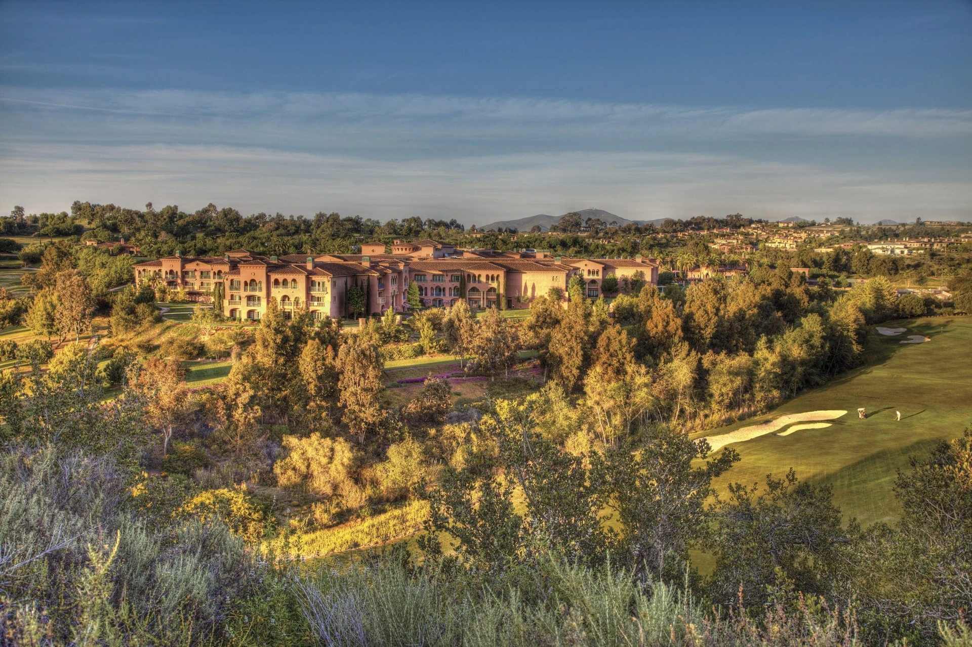 Aerial view of the resort and golf course near sunset.