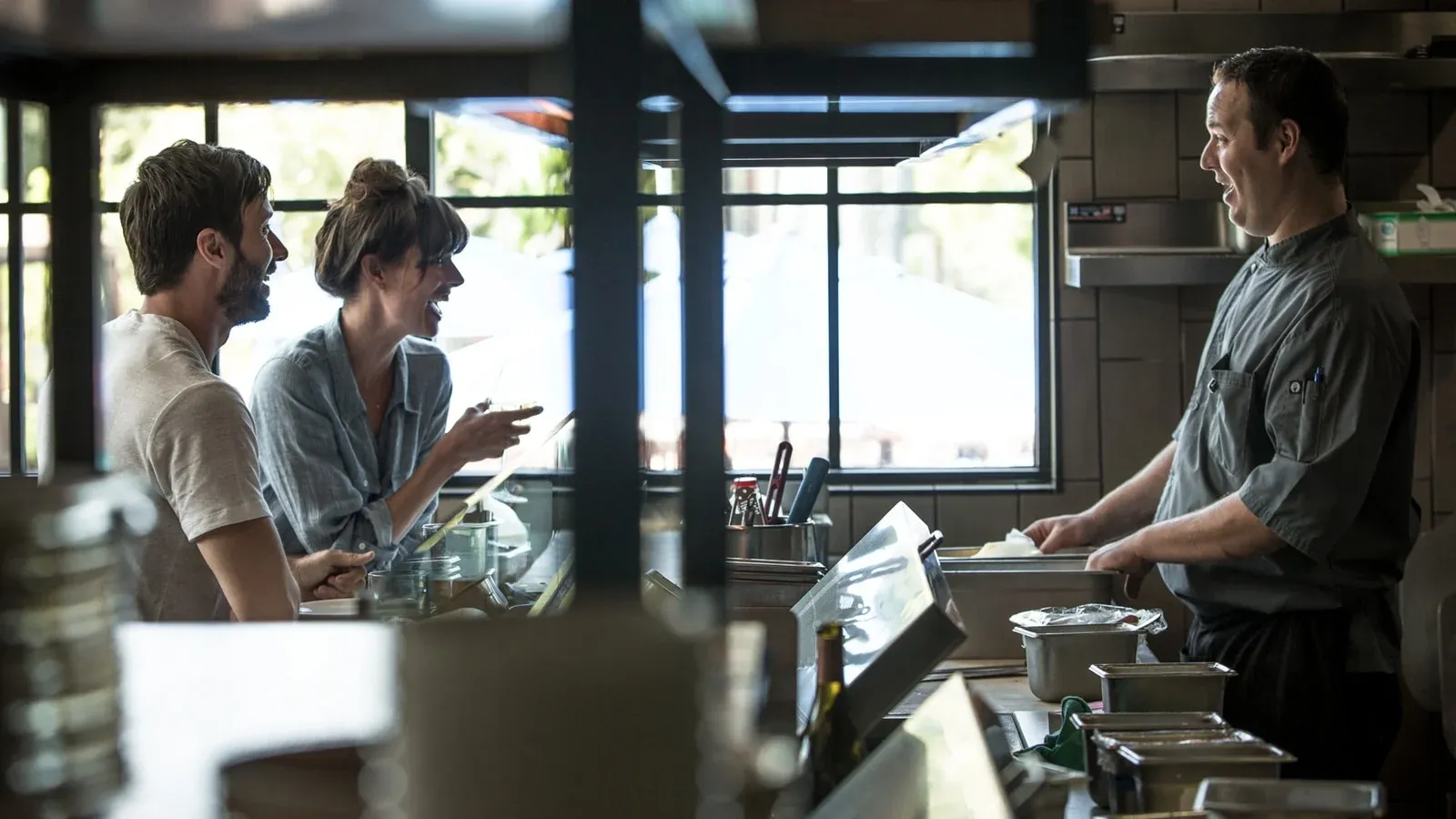 Two guests interact with a chef at the Kitchen Counter at Four Seasons Residence Club Aviara, North San Diego
