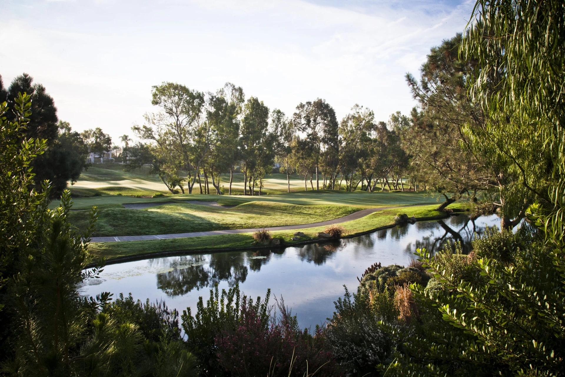 An Aviara Golf Club green near a lake.