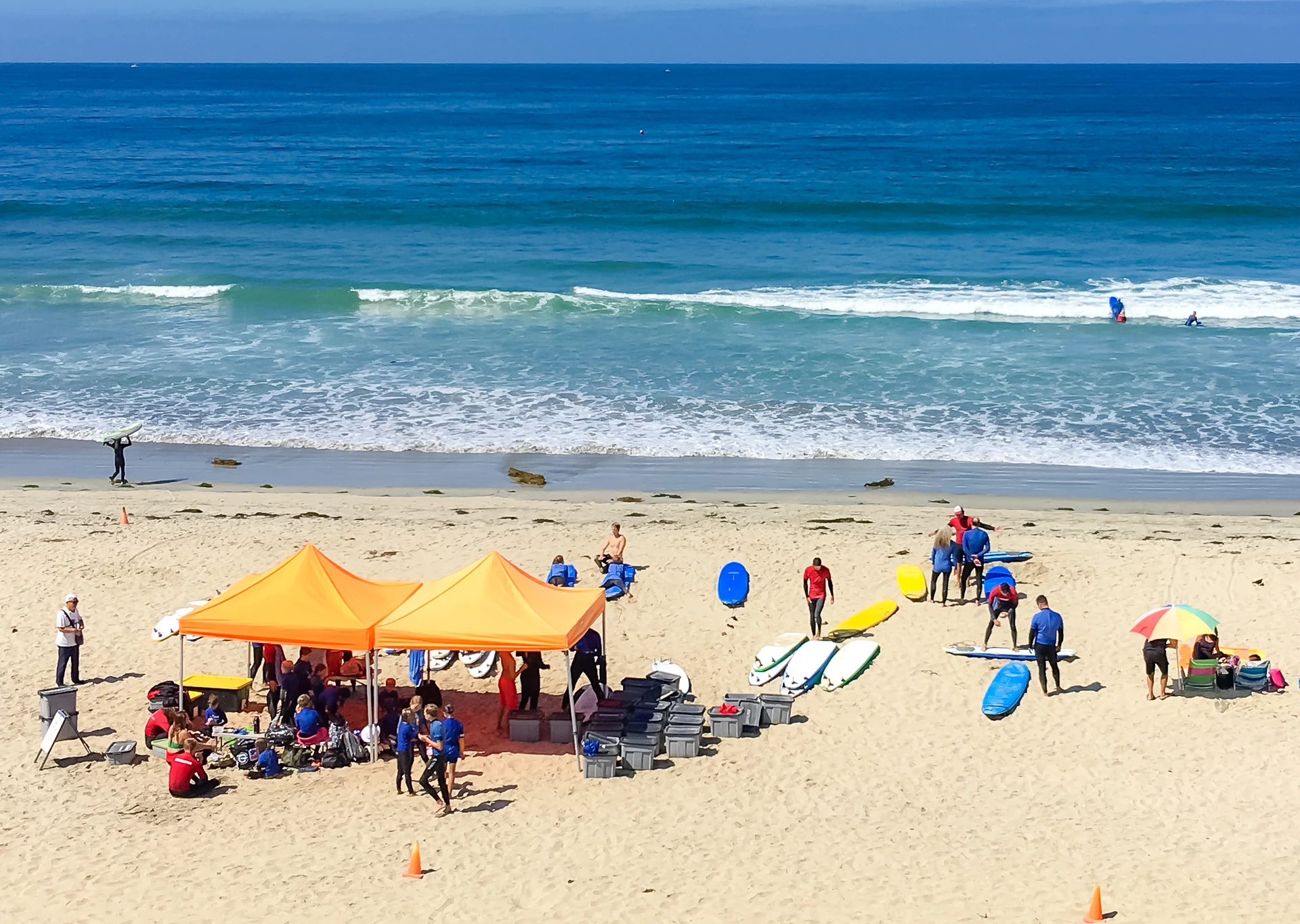 My daughter's surf school set up in Pacific Beach on a sunny day.
