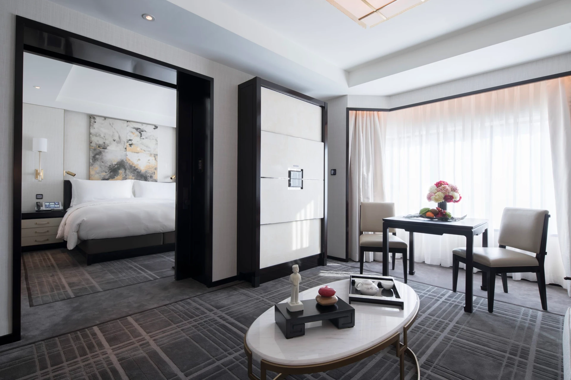 Bright, white, and grey sleek and comfortable decor at The Peninsula Beijing.