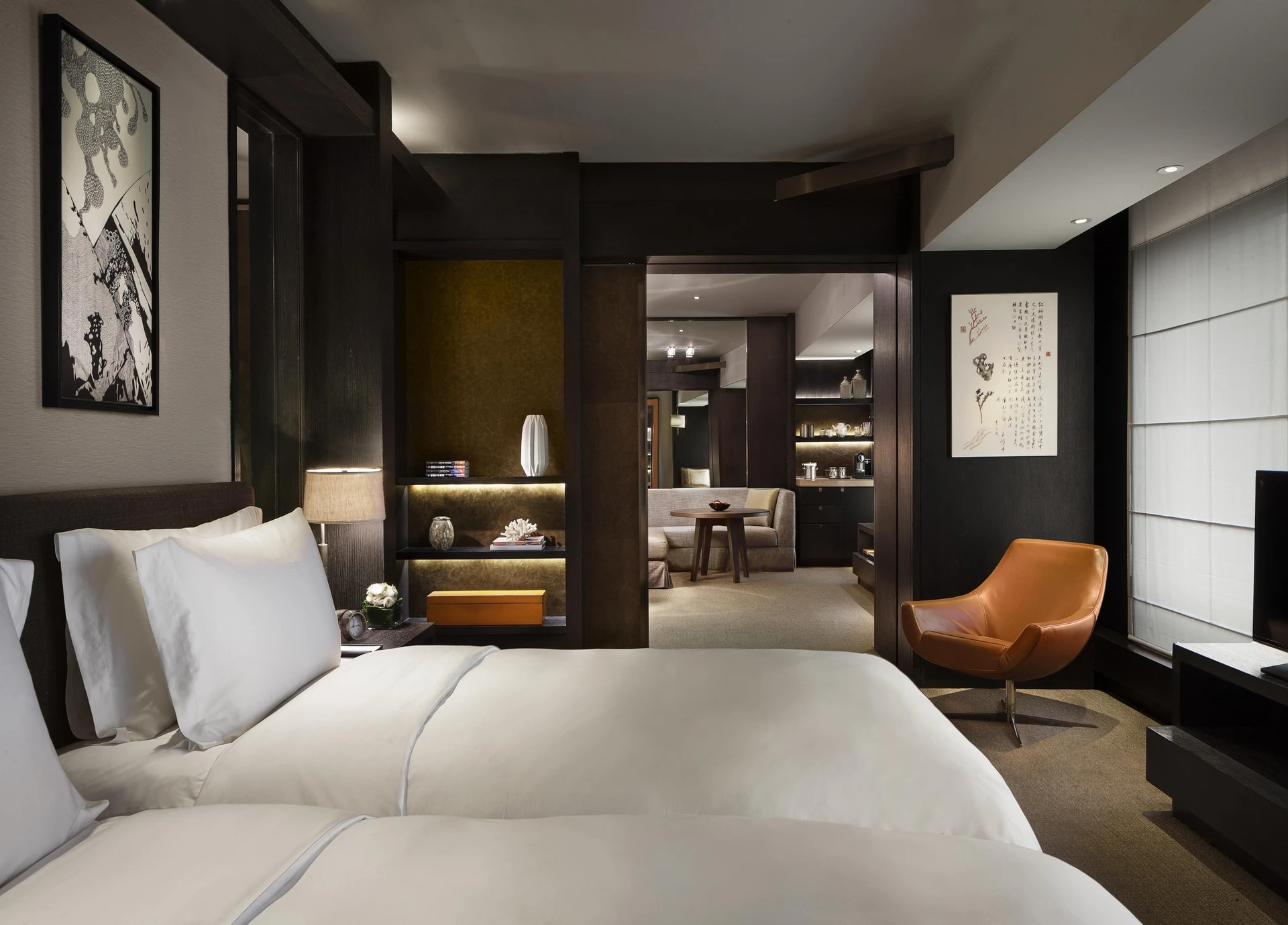 A twin room interior with dark woods at Rosewood Beijing.