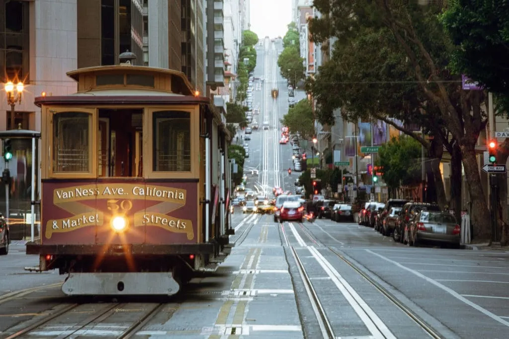 A cable car running uphill on a San Francisco street