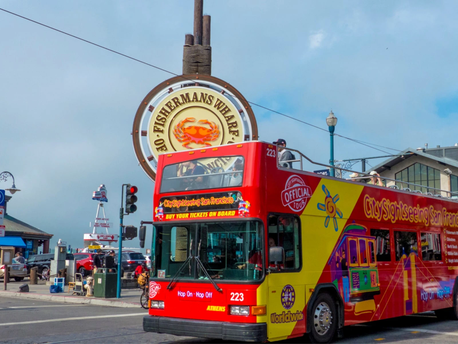 A City Sightseeing bus driving past Fisherman's Wharf