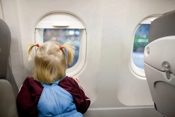 Child looking out of an airplane window