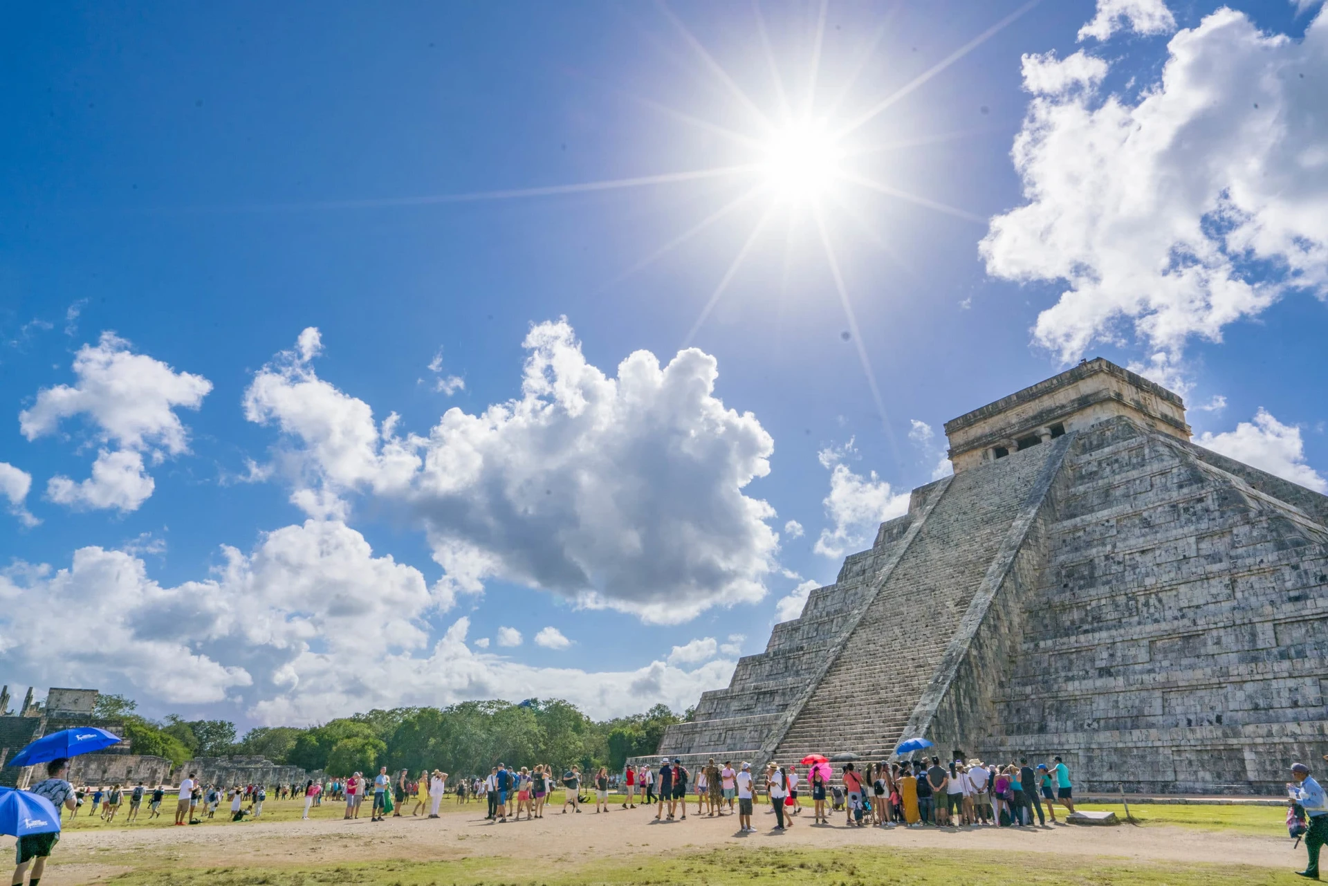 Main pyramid at Chichen-Itza under sunshine and blue skies