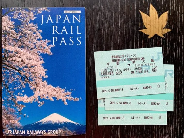 JR Pass booklet and tickets on a table.