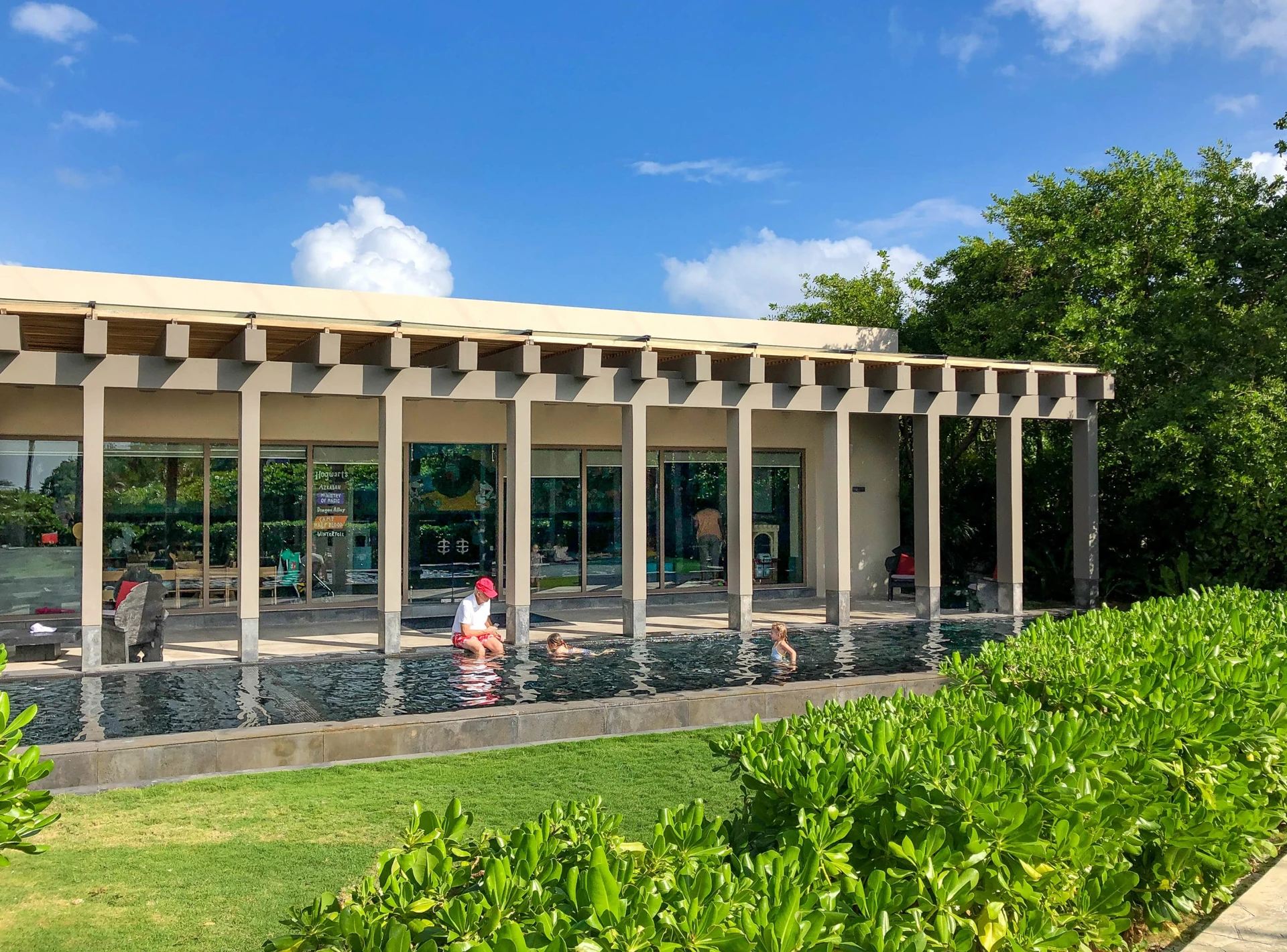 Kids swim in the pool outside of the kids' club.