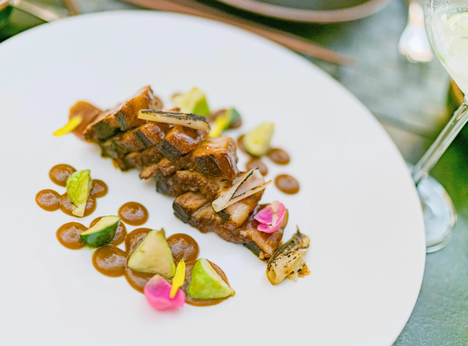 Pork belly on a white plate at Indochine inside Nizuc Resort and Spa