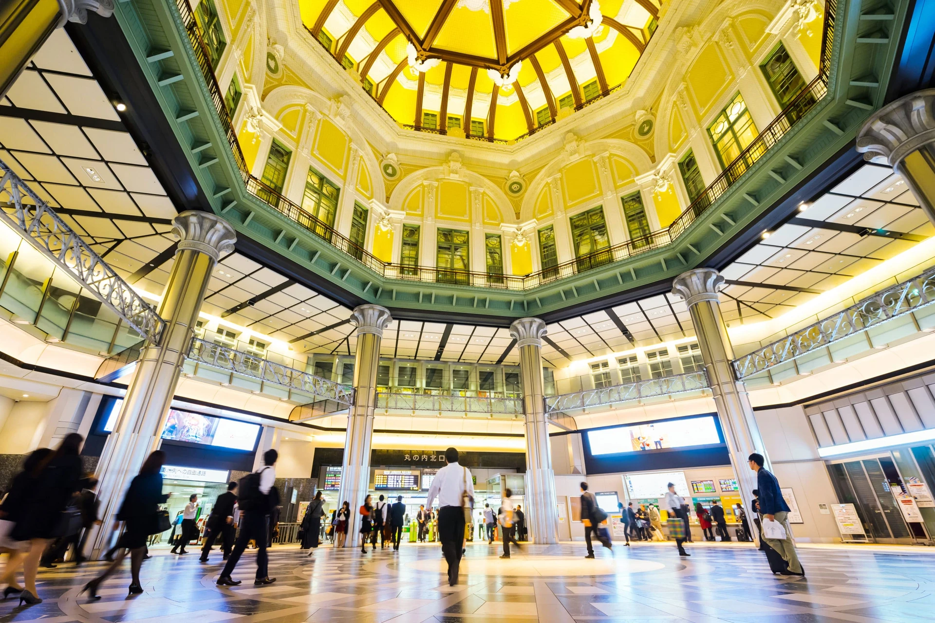 Looking up at the Tokyo Station green and yellow atrium