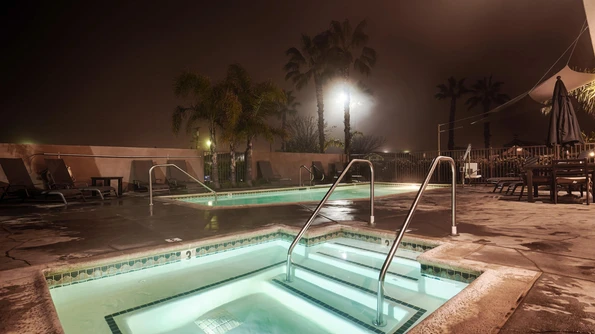 Swimming pool and jacuzzi at night