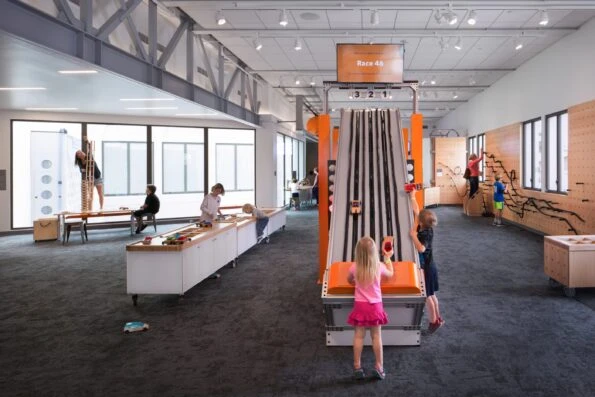 Kids playing on a speed track at Moxi Museum in Santa Barbara.