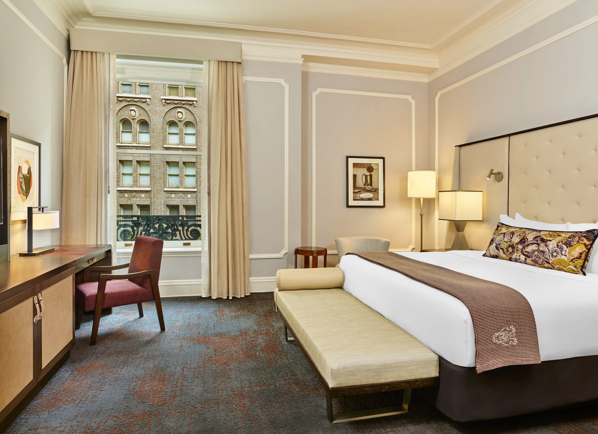 The neutral yet high-end interior of a Deluxe king room at Palace Hotel in San Francisco.