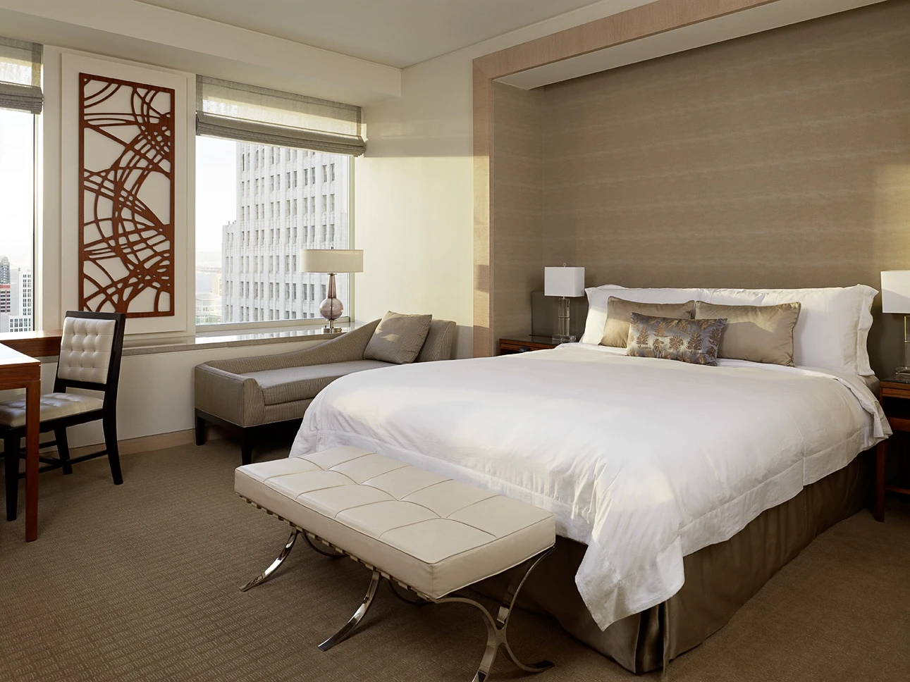 Neutral suite bedroom with red accents at The St. Regis San Francisco luxury hotel.