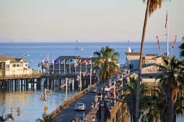 An aerial shot of cars driving down the Stearns Wharf pier in Santa Barbara.